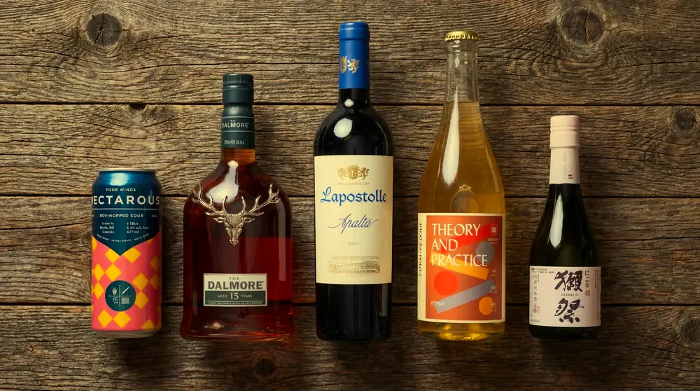 A can, wine, spirits and sake on a wooden table
